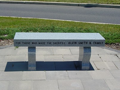 A granite bench donated by Alvin Smith & Family at the Veteran's Memorial