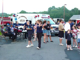 Visitors enjoy learning about the East Greenwich Ambulance Association at their booth