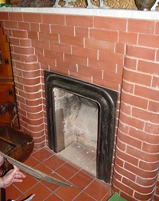 Several unglazed rounded brick fireplaces can be found in this home