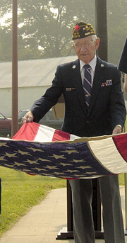 Howard DeVault, World War II Veteran and member of Anthony T. Calista VFW Post 5579 assists with the flag ceremony