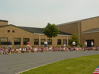 Children and teachers gather at the Samuel Mickle School