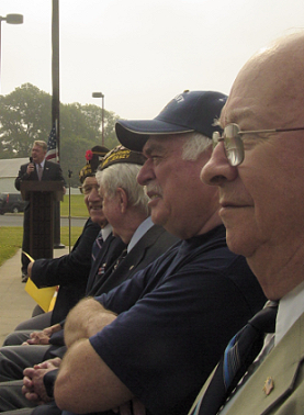 East Greenwich School Superintendent Joseph Conroy speaks as honored guests look on.