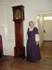 Joyce Stevenson proudly displays an antique clock, loaned to the Ann Whitall House by the Ann Whitall Chapter, DAR