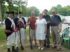 Trudy O'Hare with husband and sons, pose with revolutionary soldier re-enactors